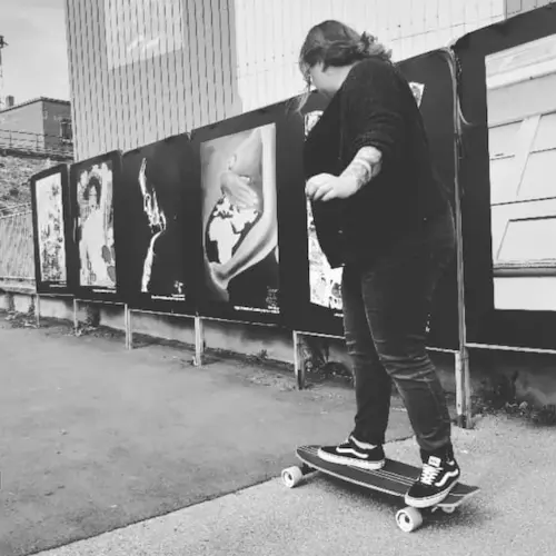 Photo of me from behind, on a skateboard, in black and white